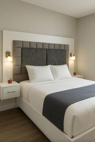 a bedroom with a large bed with a large headboard at Hermoso Apartamento para 6 personas en Yopal in Yopal