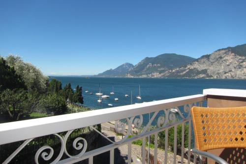 a balcony with a view of the water and boats at B&B Casa Sartori in Malcesine