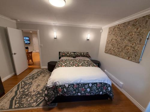 a small bedroom with a bed with a blanket at Place near the Coquitlam River Park in Coquitlam