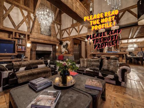 a living room with a couch and a table at Luxury Chalet Corvara with Pool & Gym in Colfosco