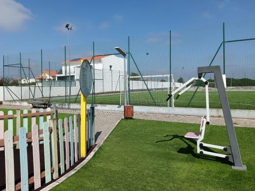 a playground with a swing set and a batting cage at Casa de Lazer da Chã in Alqueidão da Serra