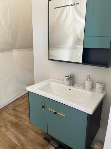 a bathroom with a sink and a mirror at Private VIP Tent in the Desert in Ḩawīyah