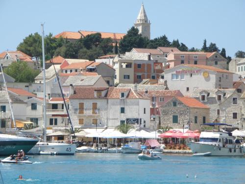 a group of boats in the water near a city at Apartment Amalija in Primošten