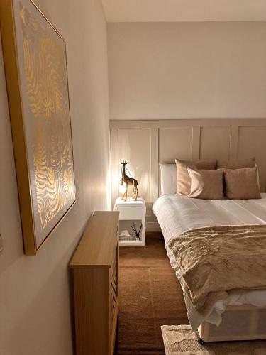 a bedroom with a bed and a statue of a horse on a table at Sky High Apartment in Streatham in London