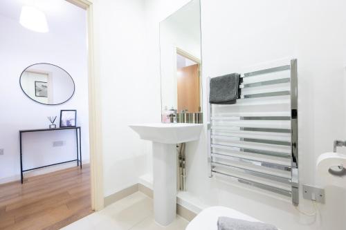 Hooにある1BR River Retreat - Sleeps 4 - Parkingの洗面台と鏡のある白いバスルーム