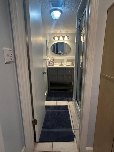 a bathroom with a sink and a mirror at Pelican Inlet-Cozy Beach Condo! in St. Augustine