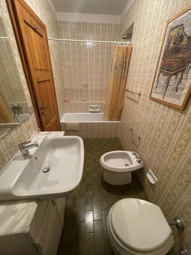 a bathroom with a white sink and a toilet at Villa Di Micco in Pescasseroli