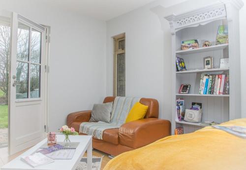 a living room with a couch and a chair at Alder House Studio in Killarney