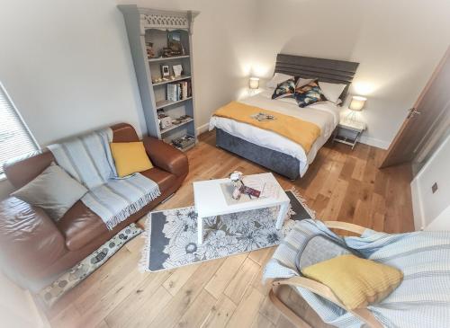 a living room with a bed and a couch at Alder House Studio in Killarney