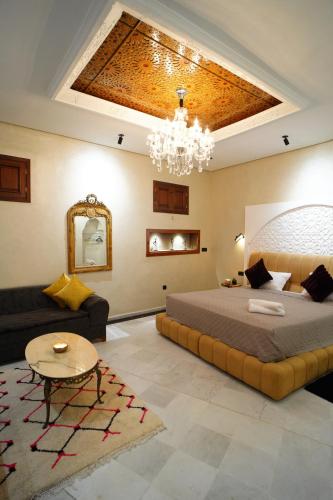 a bedroom with a large bed and a chandelier at Le 146 - Art of Living in Rabat