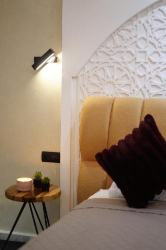 a bedroom with a bed and a lamp and a table at Le 146 - Art of Living in Rabat