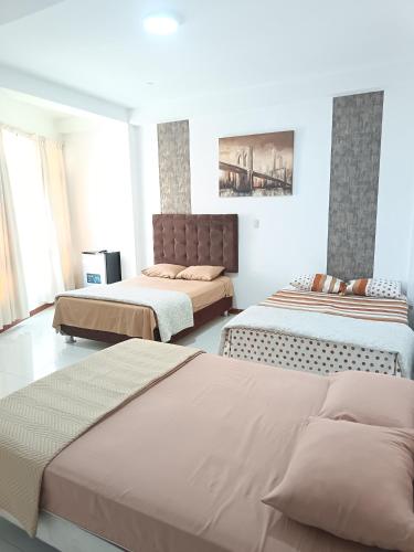 a bedroom with two beds and a couch at Casa Premium Talara in Talara
