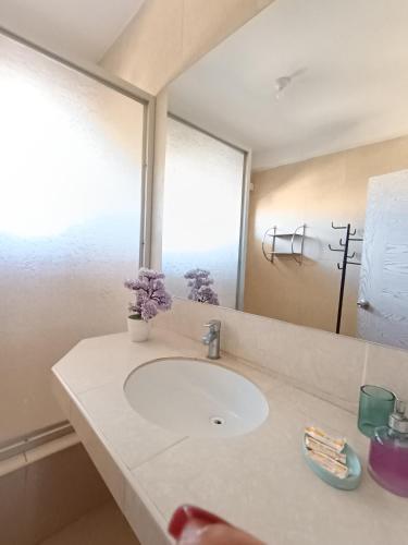 a bathroom with a sink and a mirror at Casa Premium Talara in Talara
