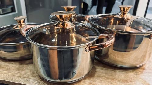 a group of silver pots sitting on a table at Ken's lower apartment in Quepos