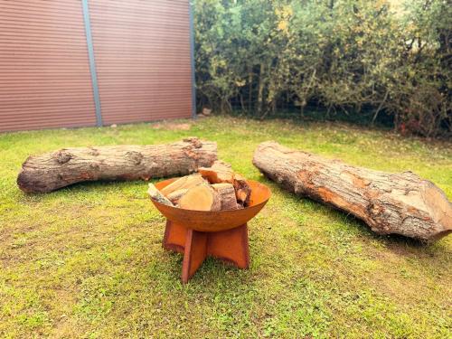 a bowl of food sitting on the grass next to a log at Luxury Glamping Pods at Pool House Farm 