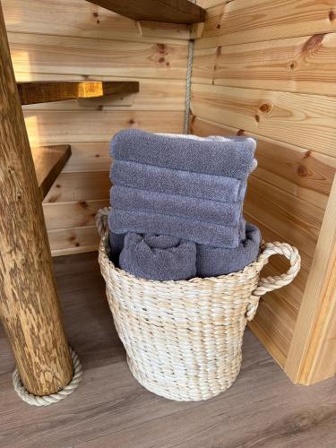 a basket filled with towels in a sauna at Luxury Tiny Home next to Belfry Golf Course Highland Cow