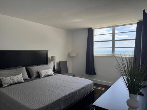 a bedroom with a bed and a large window at Beachfront 2BR at The Tides | EPIC Stay in Hollywood