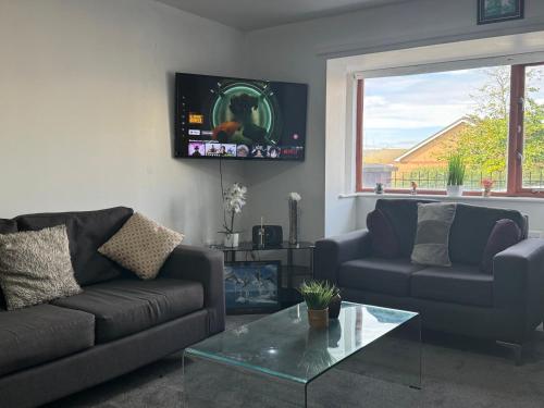 a living room with two couches and a table at Spacious Luxury Homes in Elswick