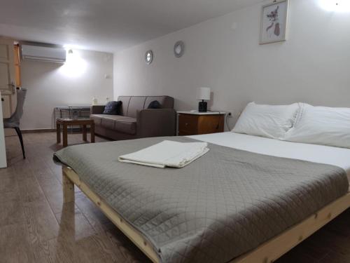 a bedroom with a large bed and a couch at Kalymnos Central Port in Kalymnos