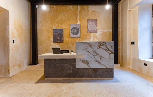 a room with a counter with drawings on the wall at Hotel Pakal 58 Centro in Mérida