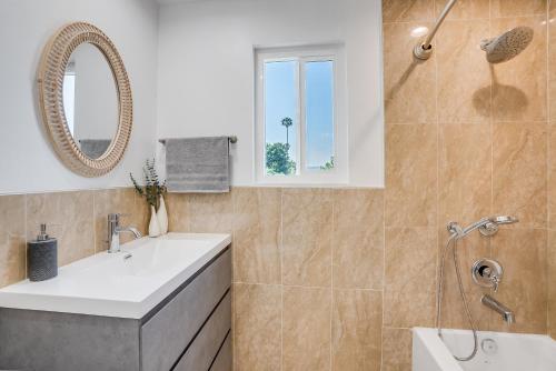 a bathroom with a white sink and a mirror at Vacation House with Pool in Garnsey