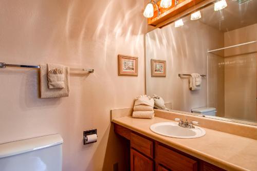 a bathroom with a sink and a toilet and a mirror at Winterpoint 42 by Ski Country Resorts in Breckenridge