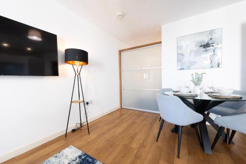 a dining room with a table and chairs and a television at 1BR River Retreat - Sleeps 4 - Parking in Hoo