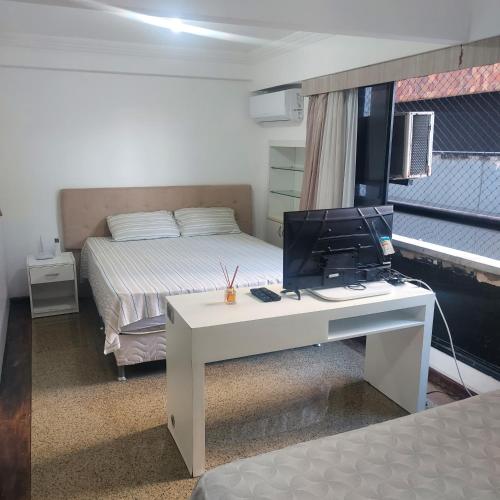 a bedroom with a desk with a computer on it at Residence Scala in Fortaleza