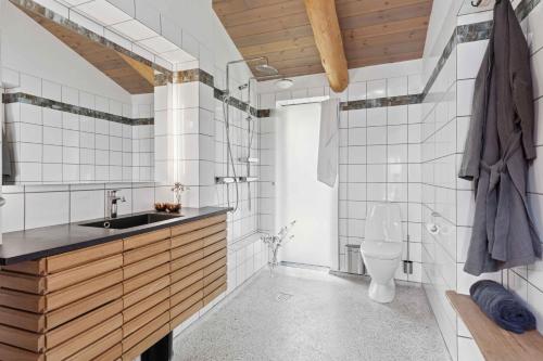 a bathroom with a sink and a toilet at Scenic 2025 Summer House With Sea View in Dokkedal