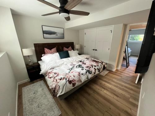 a bedroom with a bed and a ceiling fan at The West Wind Retreat in Lethbridge