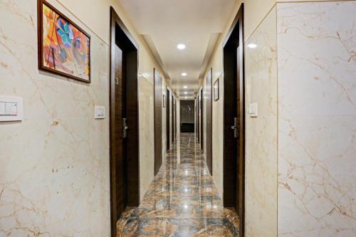 a corridor of a hotel with marble floors and walls at Collection O Vertigo Suite in Mumbai
