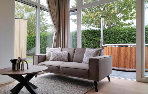 a living room with a couch and a table at 2 Bedroom Cozy Home In Heinkenszand in Graszode