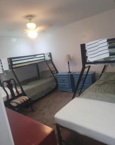 a bedroom with two bunk beds and a table at PalmBeachLake&PoolFrom69dollarsForPersonDayly 