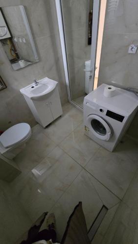 a bathroom with a toilet and a sink and a shower at Bazen za uzivanje in Petrovaradin