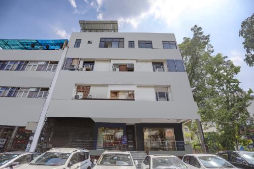 a building with cars parked in front of it at Super Hotel O Blissbourn in New Delhi