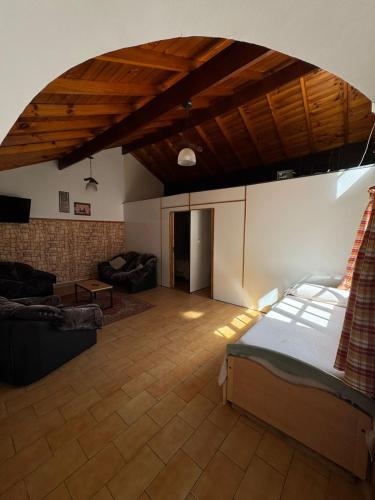 a large living room with a bed and a couch at Chalet Mar del Plata in Mar del Plata