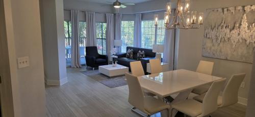 Un comedor y una sala de estar con mesa y sillas. en Modern & Luxurious 3BR Retreat!, en Orlando