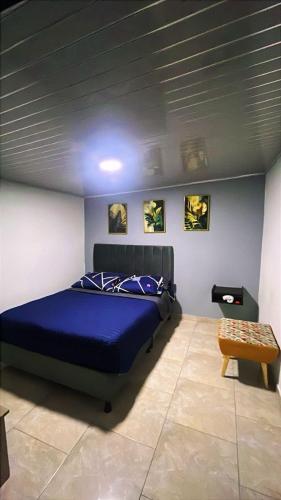 a bedroom with a blue bed in a room at Vélez Loft II in Vélez