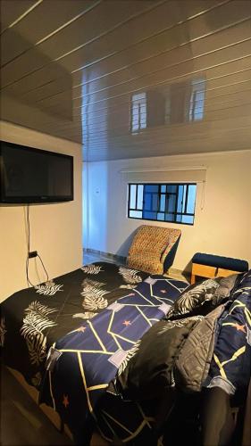 a bedroom with a bed and a flat screen tv at Vélez Loft in Vélez