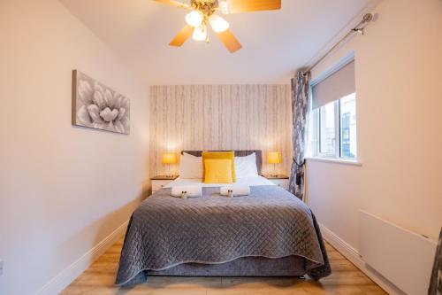 a bedroom with a bed with yellow pillows and a window at Latin Quarter Rest in Galway