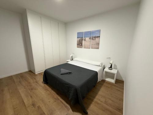 a bedroom with a bed and a picture on the wall at Vut ILLA PANCHA in Ribadeo