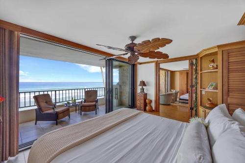 a bedroom with a bed with a view of the ocean at Paki Maui 301 · Direct Oceanfront Views Remodeled 2BD Condo in Kahana