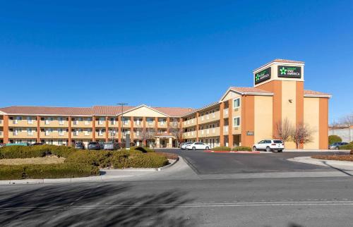 a large building with a clock tower in a parking lot at Extended Stay America Suites - Albuquerque - Airport in Albuquerque