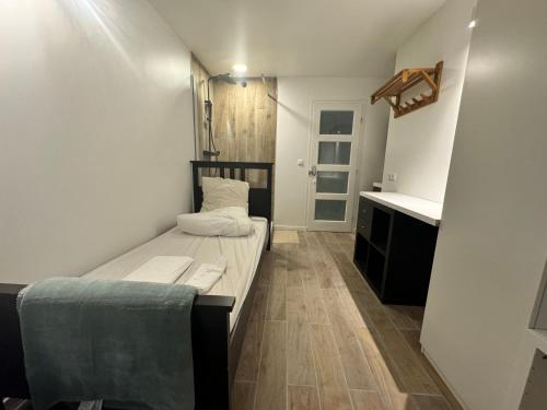 a small room with a bed and a desk at Coliving Marais in Paris