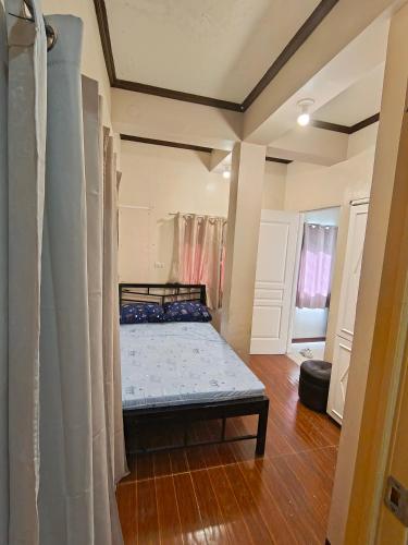 a small bedroom with a bed in a room at Transient in Davao City