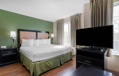 a hotel room with a bed and a flat screen tv at Extended Stay America Suites - Fremont - Fremont Blvd South in Warm Springs District