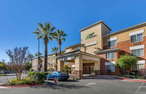 a hotel with a car parked in a parking lot at Extended Stay America Suites - San Francisco - San Carlos in San Carlos