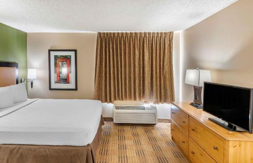 a hotel room with a bed and a flat screen tv at Extended Stay America Suites - San Francisco - San Carlos in San Carlos