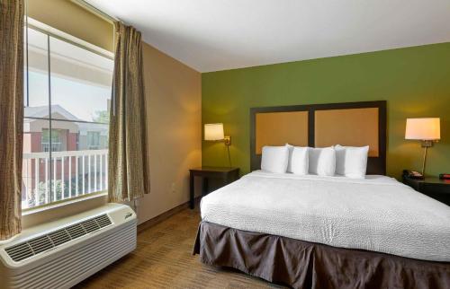 a hotel room with a bed and a large window at Extended Stay America Select Suites - Phoenix - Airport - E Oak St in Phoenix