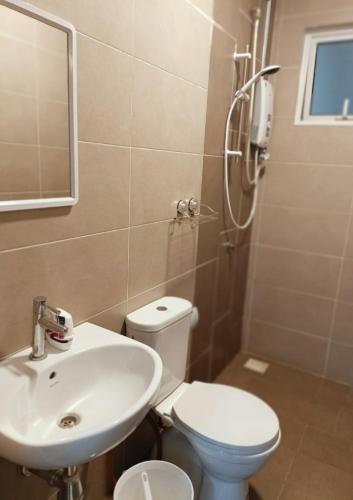 a bathroom with a sink and a toilet and a shower at Semarak Homestay@Alisya Package in Kajang
